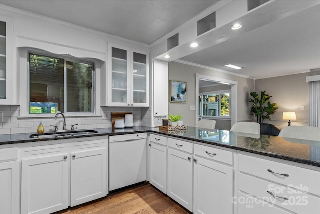 230 Shady Cove Rd, Troutman, NC 28166 - kitchen featuring dishwasher, a sink, ornamental molding, decorative backsplash, and dark stone counters