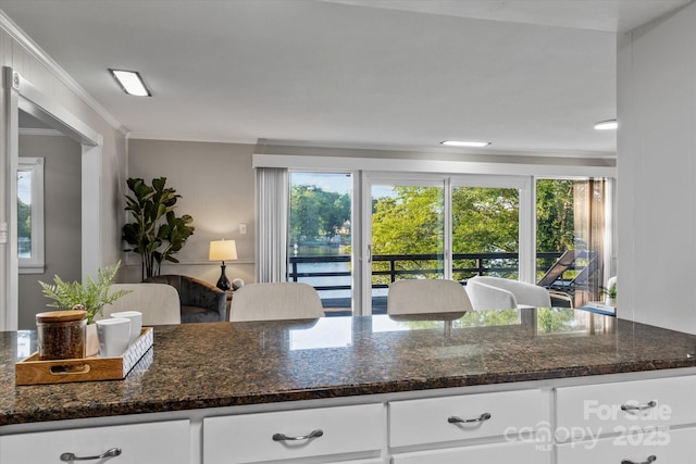 230 Shady Cove Rd, Troutman, NC 28166 - kitchen featuring dark stone counters, white cabinetry, and crown molding