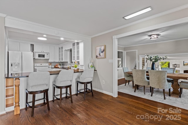 230 Shady Cove Rd, Troutman, NC 28166 - kitchen featuring white appliances, white cabinets, dark wood-type flooring, glass insert cabinets, and dark countertops