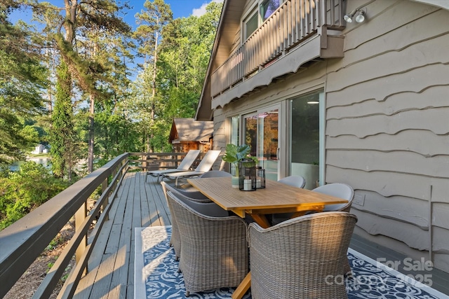 230 Shady Cove Rd, Troutman, NC 28166 - wooden deck featuring outdoor dining space and view of wooded area