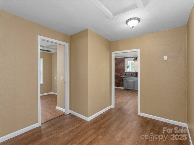 280 Noland Dr, Clyde, NC 28721 - corridor with wood finished floors, baseboards, and a sink