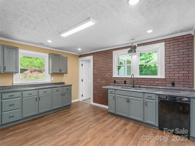 280 Noland Dr, Clyde, NC 28721 - kitchen with a sink, brick wall, black dishwasher, a textured ceiling, and ornamental molding