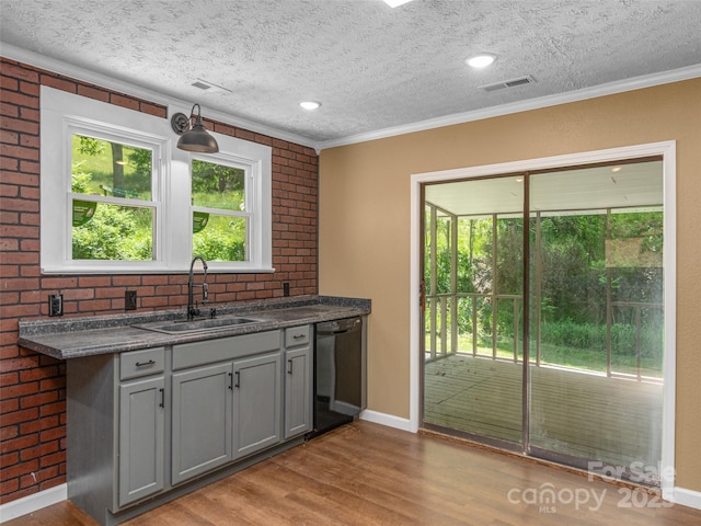 280 Noland Dr, Clyde, NC 28721 - kitchen featuring black dishwasher, a sink, wood finished floors, gray cabinets, and crown molding