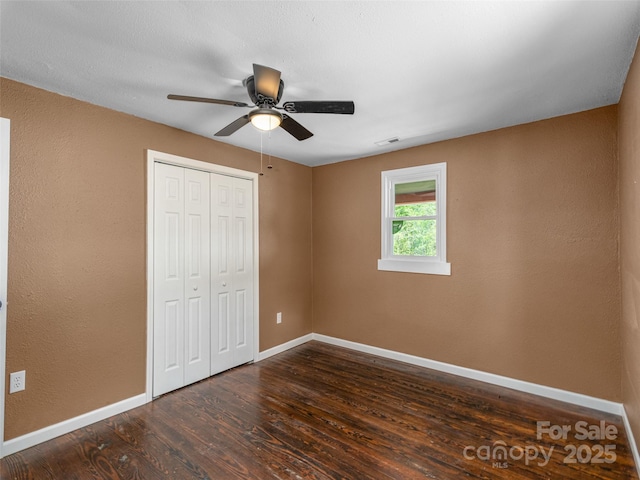 280 Noland Dr, Clyde, NC 28721 - unfurnished bedroom with baseboards, wood finished floors, a closet, and ceiling fan