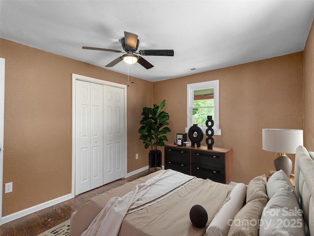 280 Noland Dr, Clyde, NC 28721 - bedroom with baseboards, wood finished floors, a closet, a textured wall, and a ceiling fan