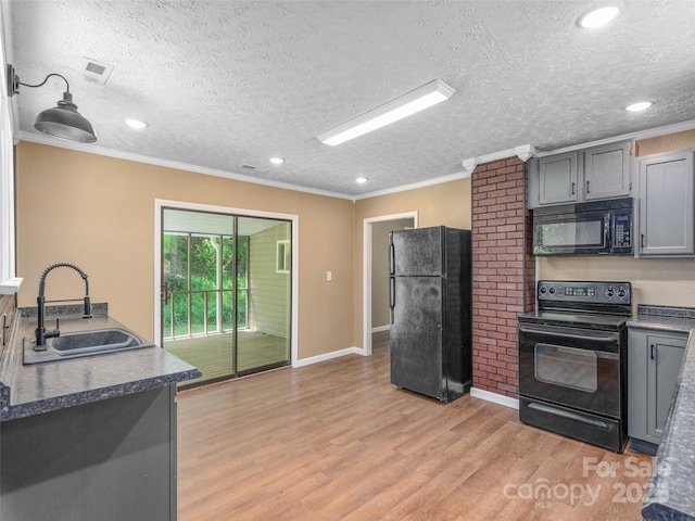 280 Noland Dr, Clyde, NC 28721 - kitchen with black appliances, a sink, a textured ceiling, crown molding, and light wood finished floors