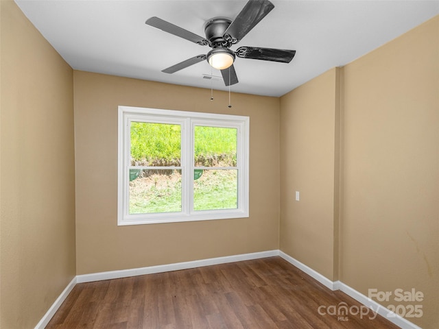 280 Noland Dr, Clyde, NC 28721 - spare room with dark wood-type flooring, baseboards, and ceiling fan
