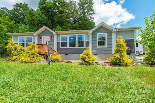 11 Bartlett Ave, Black Mountain, NC 28711 - view of front of property featuring crawl space, board and batten siding, and a front lawn