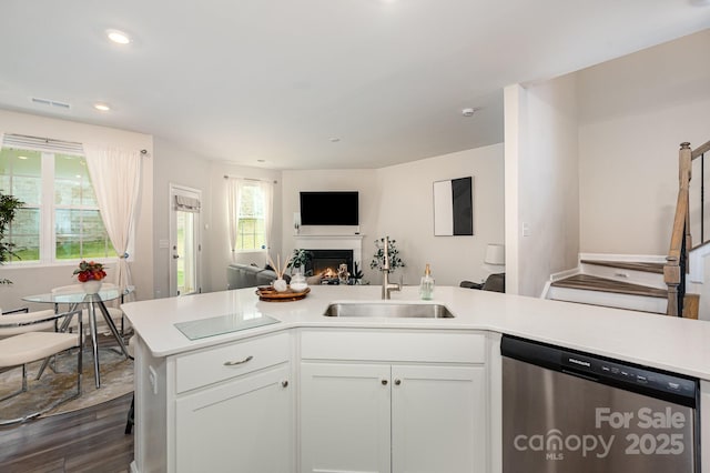 6011 Chelsea Oaks Rdg, Tega Cay, SC 29708 - kitchen featuring dishwasher, open floor plan, a sink, light countertops, and a warm lit fireplace