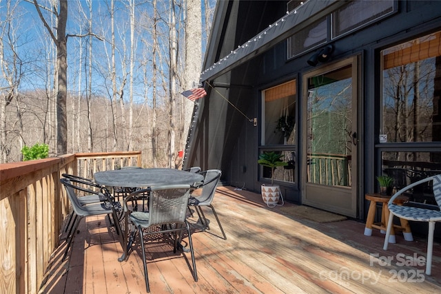 wooden deck with outdoor dining space