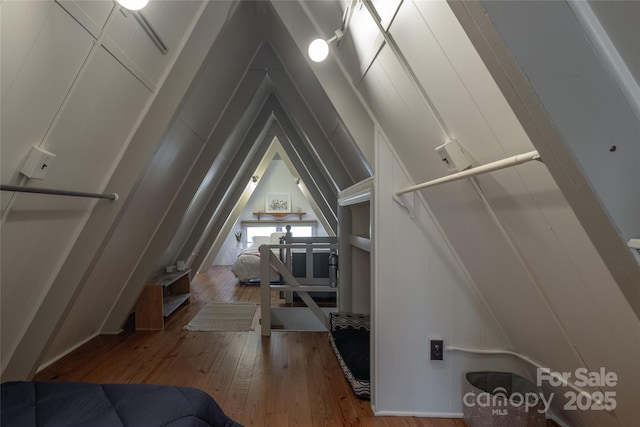 bonus room featuring hardwood / wood-style flooring and a decorative wall