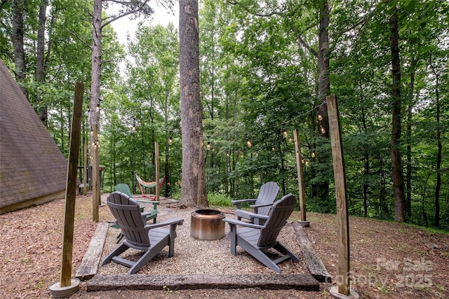 view of yard featuring an outdoor fire pit