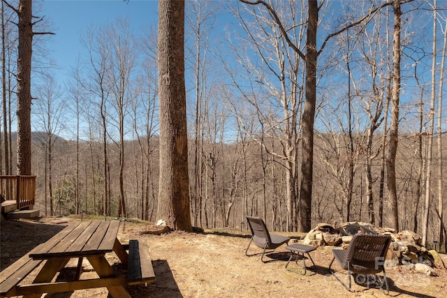 view of yard featuring a forest view