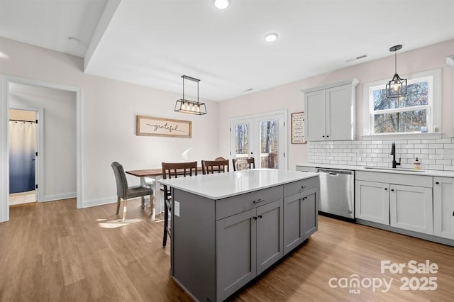 242 Delview Dr, Cherryville, NC 28021 - kitchen featuring a sink, stainless steel dishwasher, gray cabinetry, light countertops, and light wood-type flooring