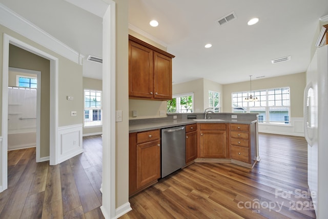 28129 Song Sparrow Ln, Fort Mill, SC 29707 - kitchen featuring dishwasher, dark wood-style floors, a peninsula, brown cabinetry, and a wainscoted wall