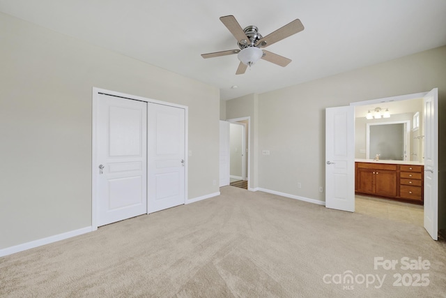 28129 Song Sparrow Ln, Fort Mill, SC 29707 - unfurnished bedroom with light colored carpet, a closet, baseboards, ensuite bath, and a ceiling fan