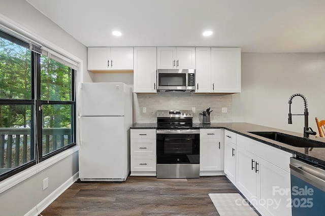 392 Tall Oaks Trl, Fort Mill, SC 29715 - kitchen with appliances with stainless steel finishes, a sink, backsplash, white cabinets, and dark wood finished floors