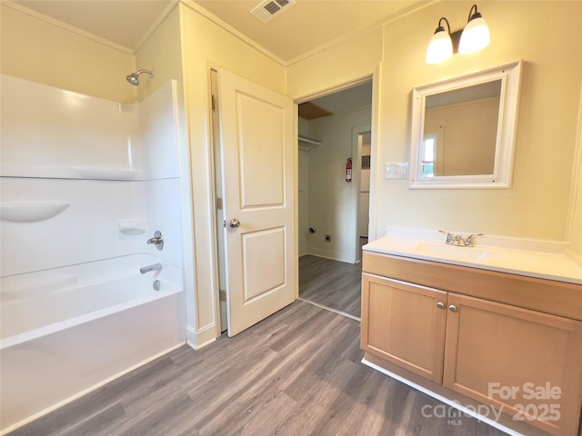 2482 E NC-10 Hwy, Conover, NC 28613 - full bath featuring wood finished floors, tub / shower combination, vanity, crown molding, and baseboards