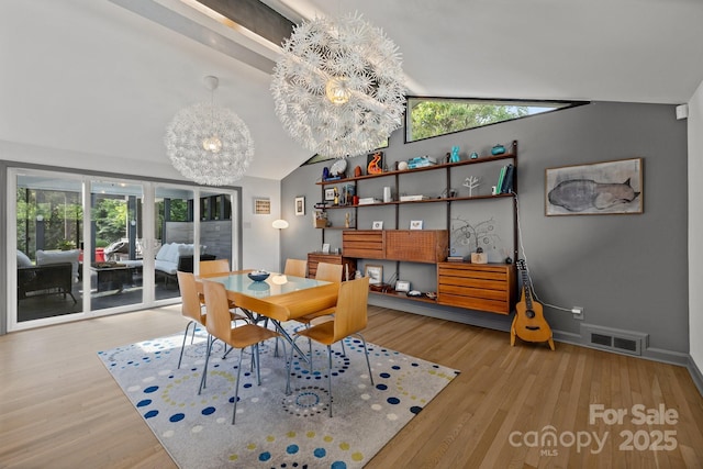 2121 Valencia Ter, Charlotte, NC 28226 - dining area with vaulted ceiling, wood finished floors, a chandelier, and baseboards