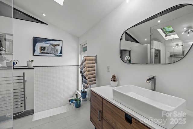 2121 Valencia Ter, Charlotte, NC 28226 - bathroom featuring a skylight, vaulted ceiling, tile patterned flooring, and vanity