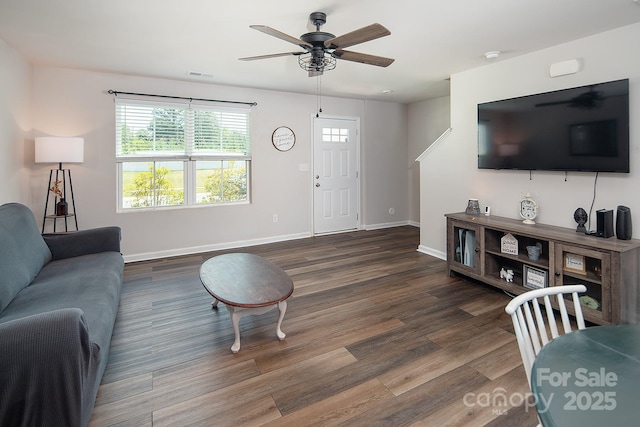 living area featuring a ceiling fan, wood finished floors, and baseboards