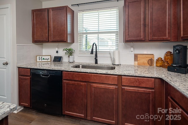 kitchen with dishwasher, a sink, backsplash, and light stone countertops