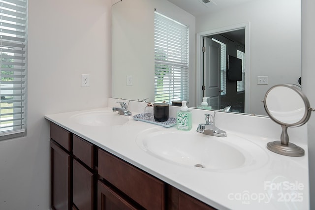 bathroom with healthy amount of natural light and double vanity
