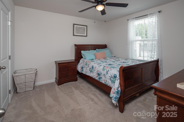 carpeted bedroom with a ceiling fan and baseboards