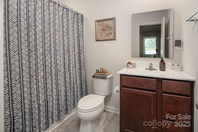 bathroom featuring toilet, vanity, tile patterned floors, and a shower with shower curtain