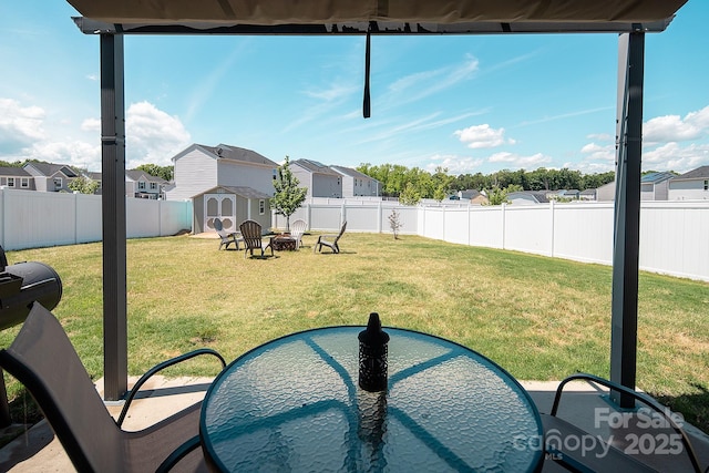 view of yard with a shed, a residential view, an outbuilding, and an outdoor fire pit