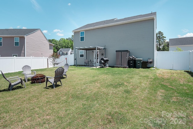 back of property with a fire pit