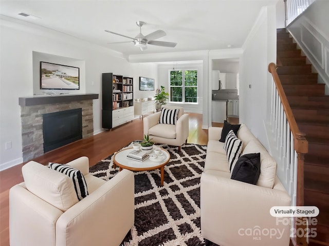 1184 Lempster Dr NW, Concord, NC 28027 - living area with a stone fireplace, ceiling fan, stairway, and wood finished floors