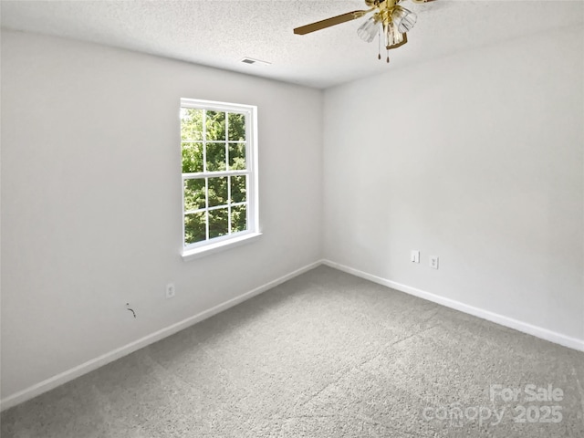 1184 Lempster Dr NW, Concord, NC 28027 - carpeted spare room featuring ceiling fan, baseboards, and a textured ceiling