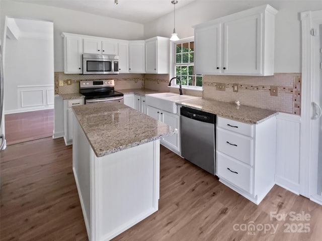 1184 Lempster Dr NW, Concord, NC 28027 - kitchen with appliances with stainless steel finishes, a kitchen island, white cabinets, and a sink