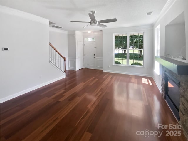 1184 Lempster Dr NW, Concord, NC 28027 - unfurnished living room with wood finished floors, a ceiling fan, stairway, a glass covered fireplace, and ornamental molding