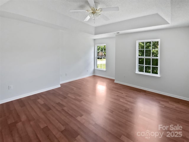 1184 Lempster Dr NW, Concord, NC 28027 - spare room with plenty of natural light, wood finished floors, ceiling fan, baseboards, and a textured ceiling