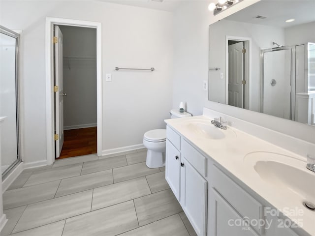 1184 Lempster Dr NW, Concord, NC 28027 - bathroom featuring a stall shower, double vanity, baseboards, toilet, and tile patterned flooring