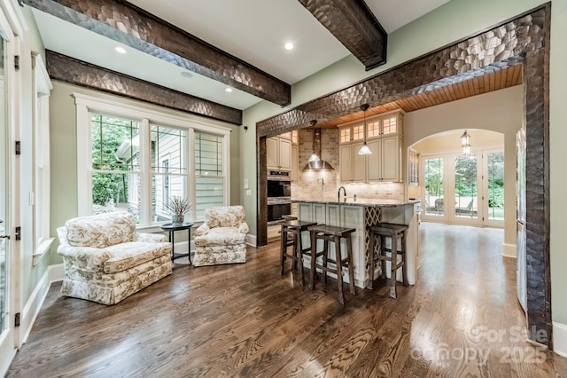 157 Dedham Loop, Mooresville, NC 28117 - kitchen with beamed ceiling, arched walkways, a breakfast bar, dark wood-type flooring, and double oven