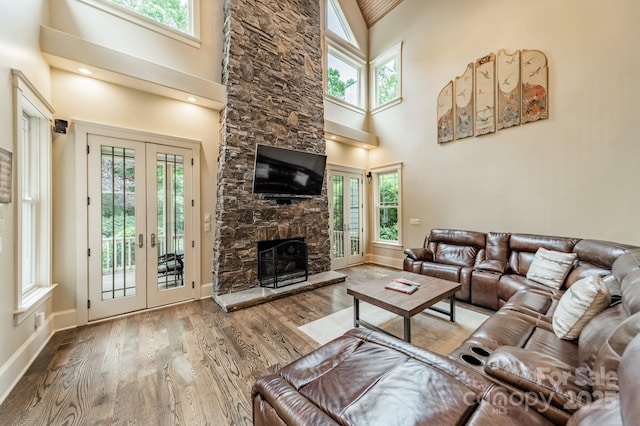 157 Dedham Loop, Mooresville, NC 28117 - living area featuring french doors, high vaulted ceiling, healthy amount of natural light, and wood finished floors