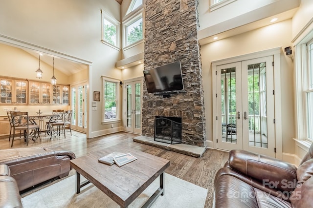 157 Dedham Loop, Mooresville, NC 28117 - living room featuring french doors, a high ceiling, plenty of natural light, and wood finished floors