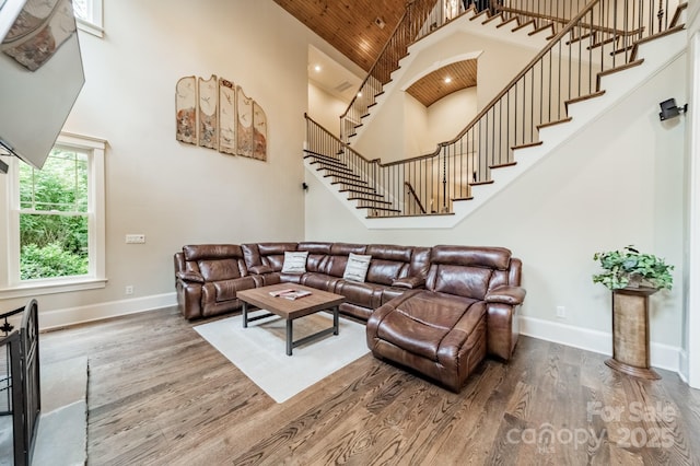 157 Dedham Loop, Mooresville, NC 28117 - living area featuring high vaulted ceiling, wood finished floors, stairs, baseboards, and wood ceiling