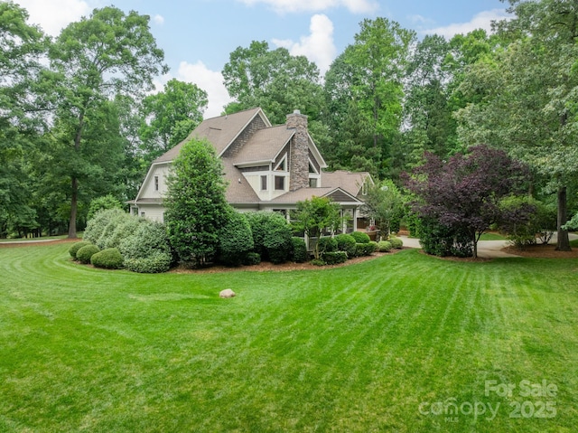 157 Dedham Loop, Mooresville, NC 28117 - view of home's exterior with a lawn and a chimney