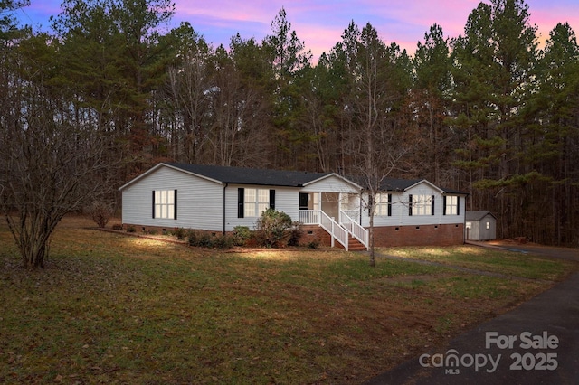 1370 Poole Rd, Salisbury, NC 28146 - manufactured / mobile home featuring crawl space, a storage shed, a lawn, and an outbuilding