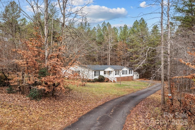 1370 Poole Rd, Salisbury, NC 28146 - view of front of home featuring asphalt driveway, a front yard, and a forest view