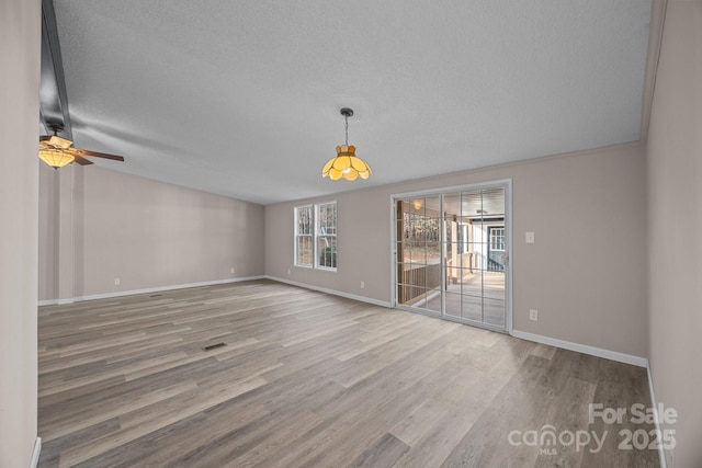 1370 Poole Rd, Salisbury, NC 28146 - empty room featuring wood finished floors, baseboards, a ceiling fan, a textured ceiling, and vaulted ceiling