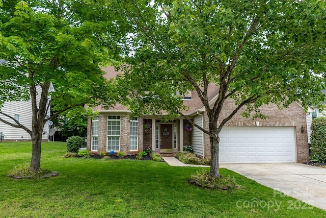 5656 Cambridge Bay Dr, Charlotte, NC 28269 - obstructed view of property with concrete driveway, a front lawn, a garage, and brick siding