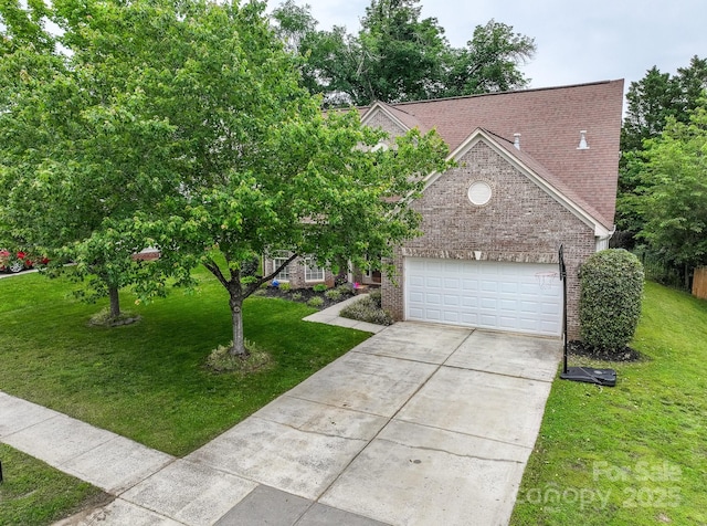 5656 Cambridge Bay Dr, Charlotte, NC 28269 - view of front of house with brick siding, concrete driveway, a front lawn, and an attached garage