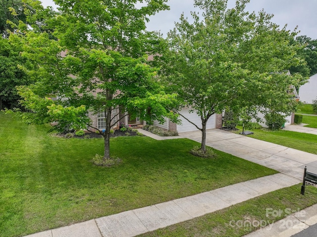 5656 Cambridge Bay Dr, Charlotte, NC 28269 - obstructed view of property with driveway, a front yard, and an attached garage