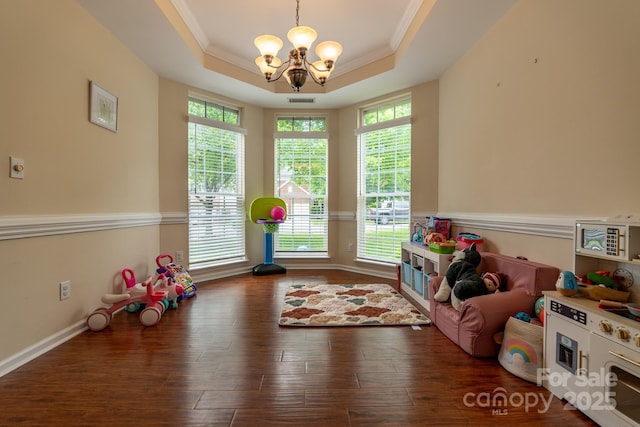 5656 Cambridge Bay Dr, Charlotte, NC 28269 - playroom with a chandelier, wood finished floors, a tray ceiling, crown molding, and baseboards
