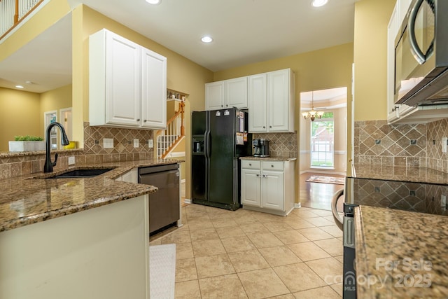 5656 Cambridge Bay Dr, Charlotte, NC 28269 - kitchen with black fridge with ice dispenser, stainless steel dishwasher, a sink, light stone counters, and tasteful backsplash